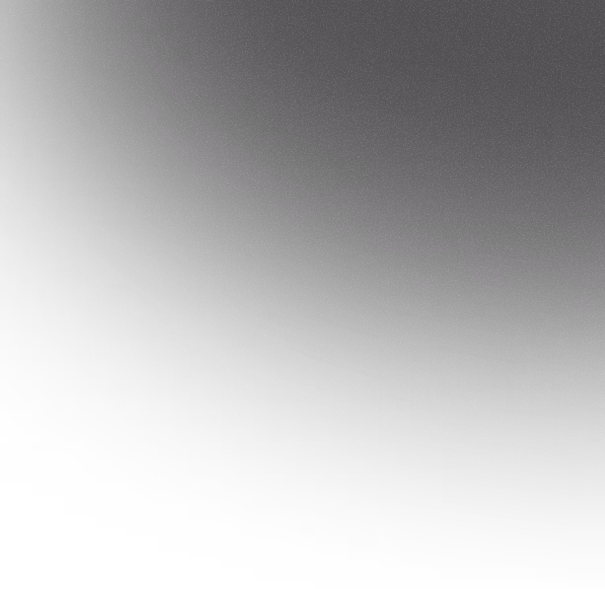 Close-up view of the textured black surface with a subtle curved gradient and fine white speckles around the edge.